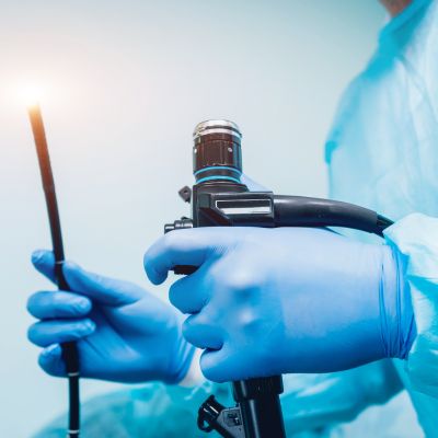 Doctor holding an endoscope in preparation for an endoscopy