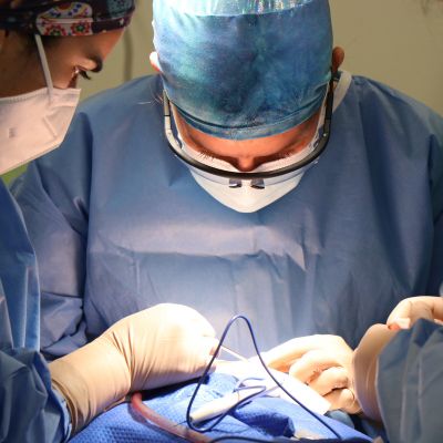 Surgeons performing thoracic surgery on a patient’s thoracic cavity