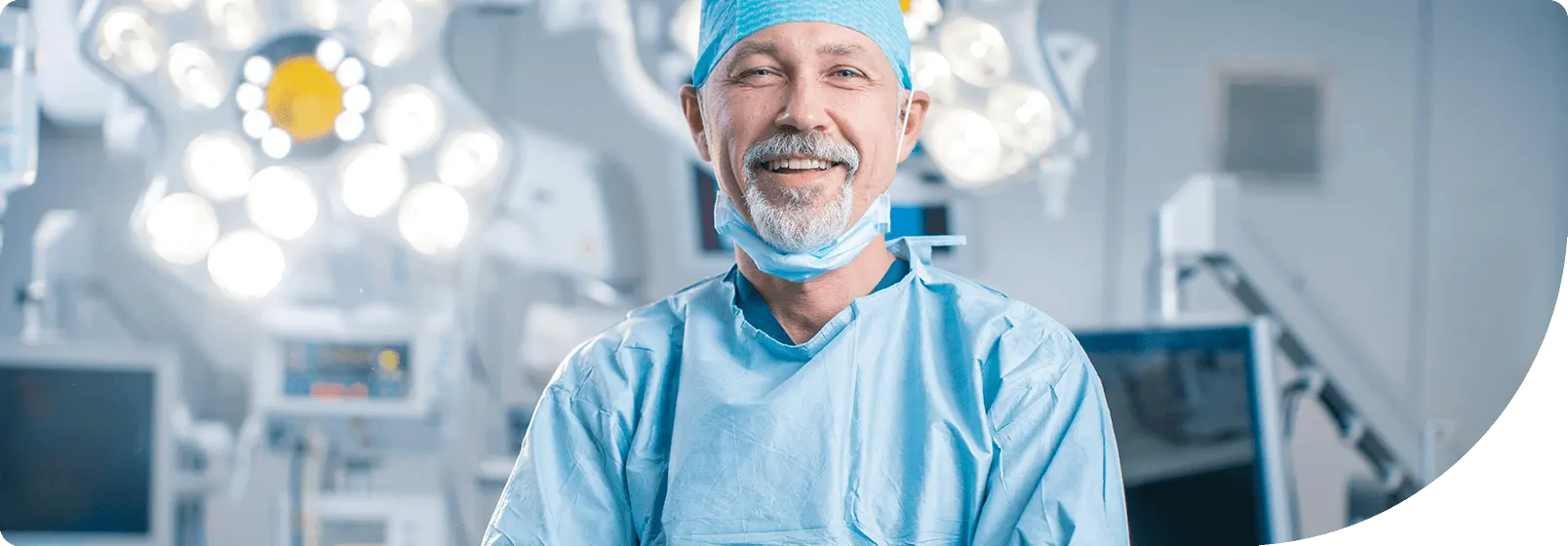 older male doctor wearing scrubs in the operating room