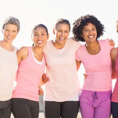 Women lined up wearing pink with their arms around each other