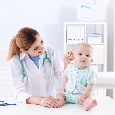 Doctor checking a baby's temperature