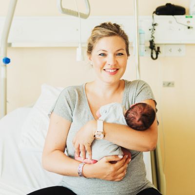 mother holding her infant in a hospital room