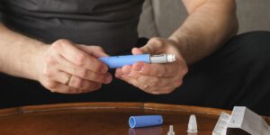 man preparing to use medications for weight loss